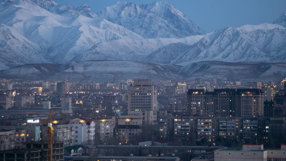 Bishkek city with snow covered mountains behind it
