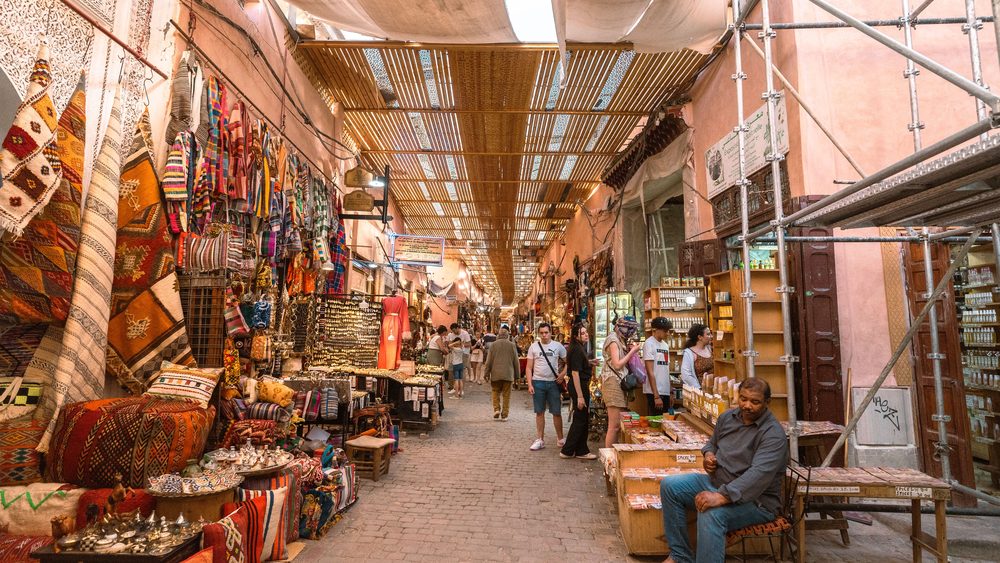 A busy souk street in Marrakech with colorful stalls